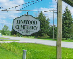 Sign for Linwood Cemetery on a clear day.